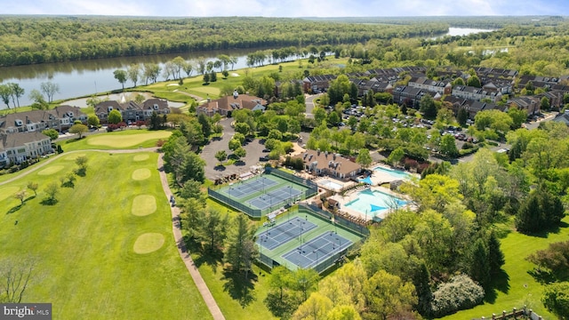 drone / aerial view featuring a water view, a view of trees, a residential view, and golf course view
