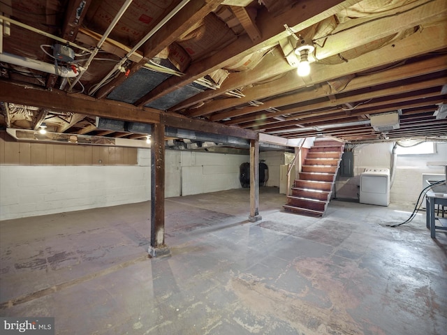 unfinished below grade area with washer / dryer, heating fuel, stairway, and electric panel