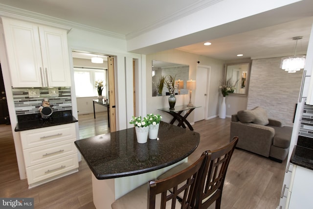 13909 Broomall Ln, Silver Spring, MD 20906 - dining room featuring recessed lighting, ornamental molding, wood finished floors, and a notable chandelier