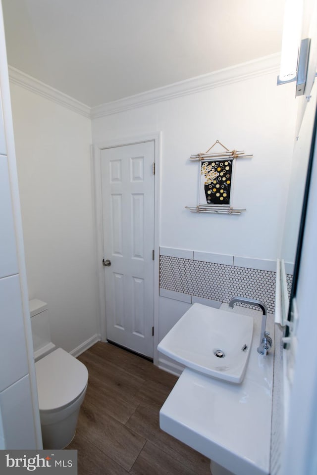 13909 Broomall Ln, Silver Spring, MD 20906 - bathroom with ornamental molding, toilet, and wood finished floors