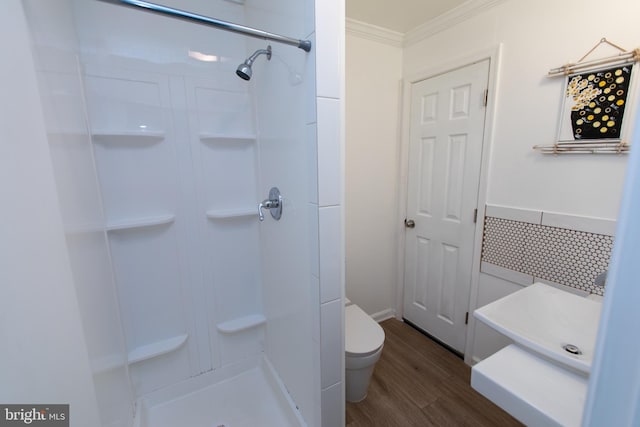 13909 Broomall Ln, Silver Spring, MD 20906 - bathroom featuring toilet, ornamental molding, wood finished floors, and a stall shower