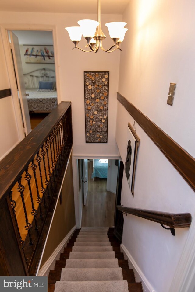 13909 Broomall Ln, Silver Spring, MD 20906 - stairway with wood finished floors and a notable chandelier