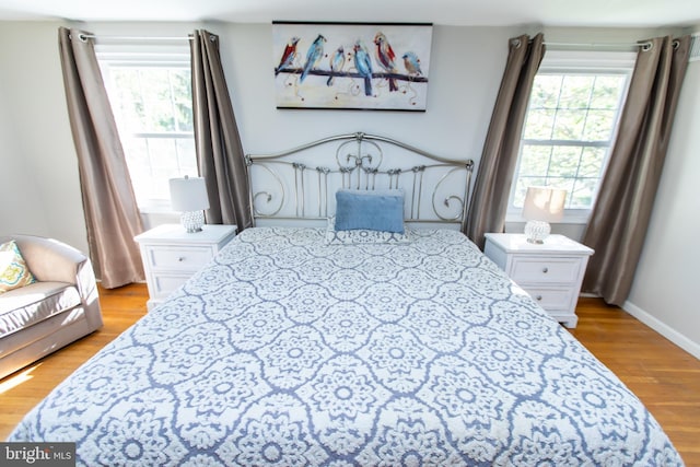 13909 Broomall Ln, Silver Spring, MD 20906 - bedroom featuring baseboards, multiple windows, and light wood-style floors