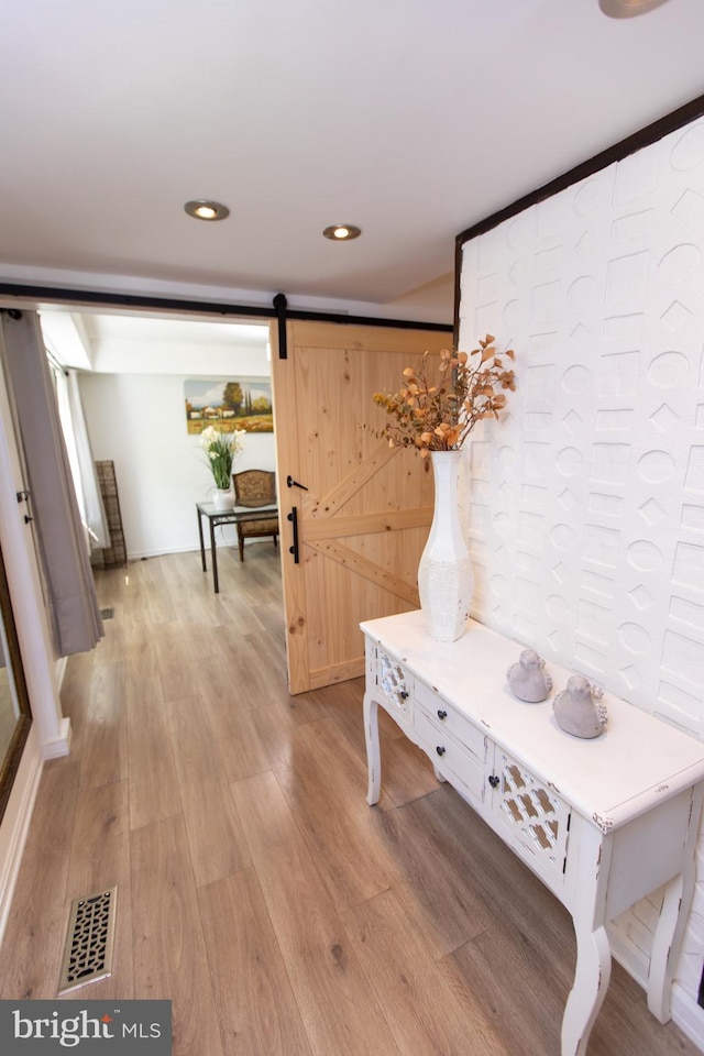 13909 Broomall Ln, Silver Spring, MD 20906 - hall featuring light wood-style floors, a barn door, and visible vents