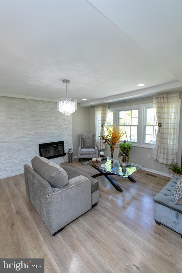 13909 Broomall Ln, Silver Spring, MD 20906 - living room with visible vents, wood finished floors, a fireplace, baseboards, and a notable chandelier