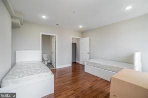 bedroom with recessed lighting and wood finished floors