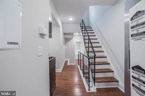 staircase with wood finished floors