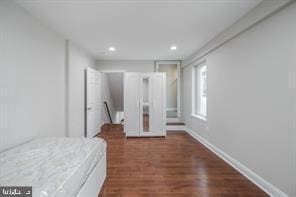 bedroom with baseboards, recessed lighting, and dark wood finished floors