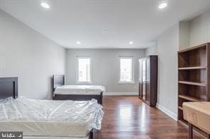 bedroom with baseboards, recessed lighting, and wood finished floors