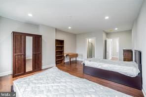 bedroom featuring baseboards, recessed lighting, and wood finished floors