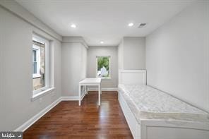 unfurnished bedroom with baseboards, dark wood-style floors, and recessed lighting