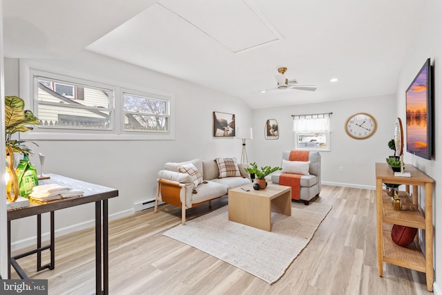 living room featuring a baseboard heating unit, light wood-type flooring, baseboards, and recessed lighting