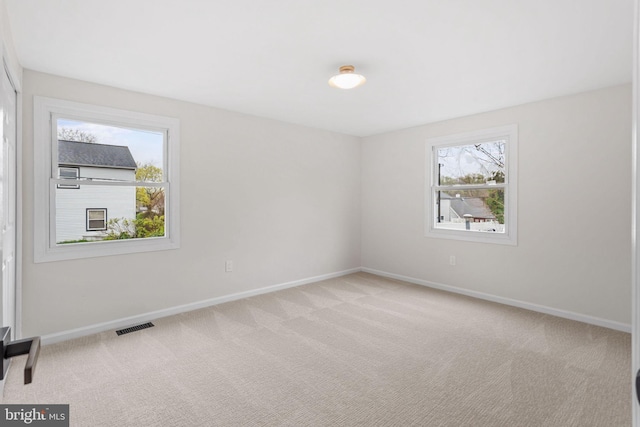 empty room with baseboards and carpet