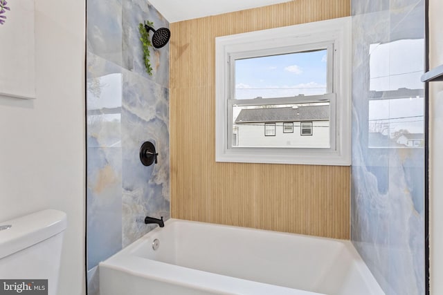 full bath featuring toilet and washtub / shower combination