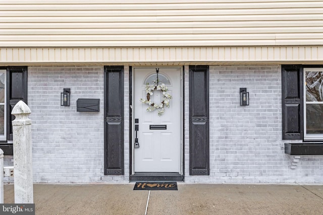 property entrance with brick siding