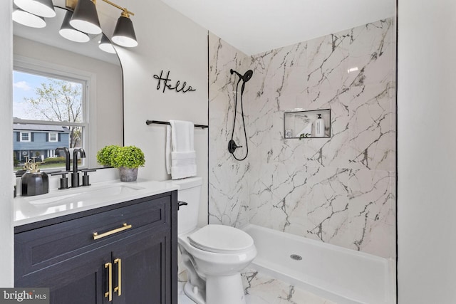 bathroom with marble finish floor, vanity, a marble finish shower, and toilet