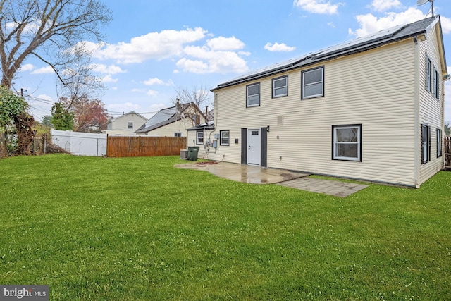 rear view of property with cooling unit, a lawn, a patio, and fence