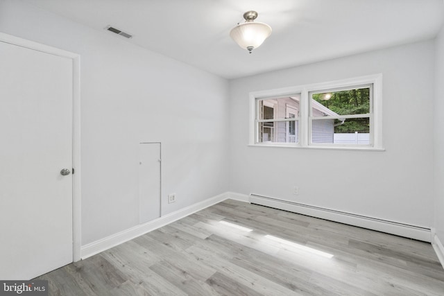 1302 Ashbridge Rd, West Chester, PA 19380 - empty room featuring a baseboard radiator, wood finished floors, and baseboards