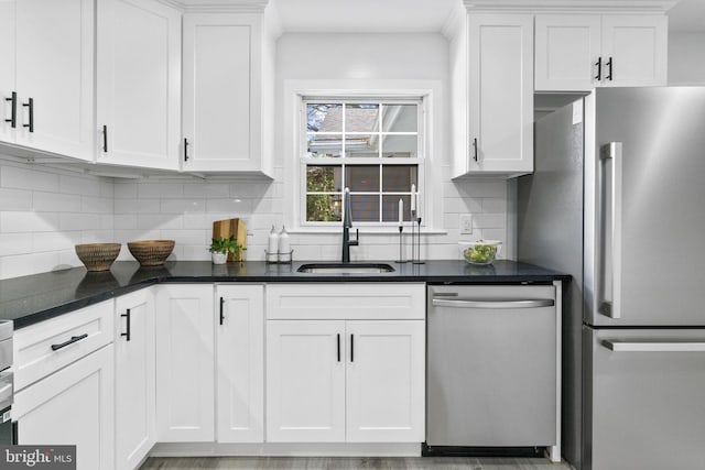 1302 Ashbridge Rd, West Chester, PA 19380 - kitchen featuring stainless steel appliances, a sink, white cabinets, tasteful backsplash, and dark stone countertops