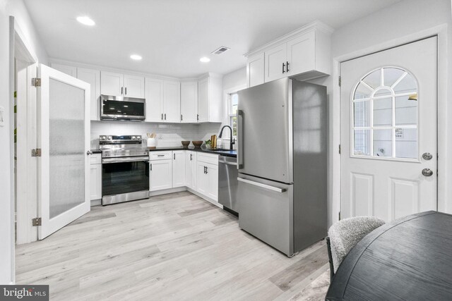 1302 Ashbridge Rd, West Chester, PA 19380 - kitchen featuring appliances with stainless steel finishes, a sink, light wood-style flooring, white cabinetry, and recessed lighting