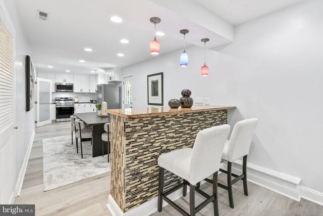 1302 Ashbridge Rd, West Chester, PA 19380 - indoor dry bar featuring appliances with stainless steel finishes, baseboards, recessed lighting, and light wood finished floors