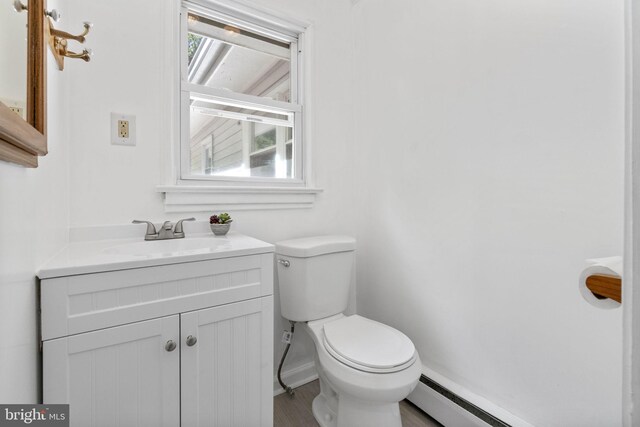1302 Ashbridge Rd, West Chester, PA 19380 - bathroom featuring toilet, vanity, baseboards, a baseboard radiator, and wood finished floors