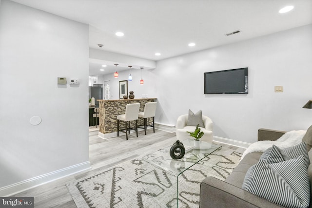 1302 Ashbridge Rd, West Chester, PA 19380 - living area with wood finished floors, baseboards, recessed lighting, and bar area