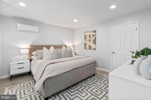 1302 Ashbridge Rd, West Chester, PA 19380 - bedroom featuring an AC wall unit, light wood-style floors, recessed lighting, and baseboards