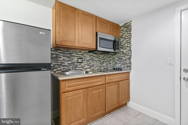 1302 Ashbridge Rd, West Chester, PA 19380 - kitchen with appliances with stainless steel finishes, a sink, decorative backsplash, light tile patterned floors, and light countertops
