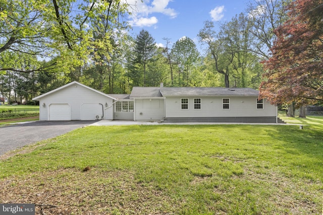 1302 Ashbridge Rd, West Chester, PA 19380 - view of front facade featuring asphalt driveway, an attached garage, a front yard, and view of scattered trees