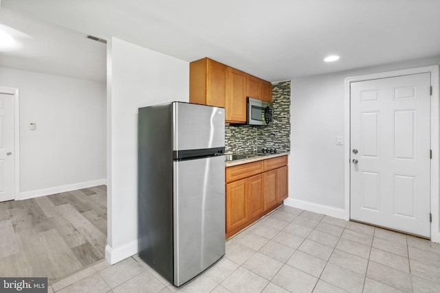 1302 Ashbridge Rd, West Chester, PA 19380 - kitchen with appliances with stainless steel finishes, decorative backsplash, light countertops, light tile patterned flooring, and recessed lighting