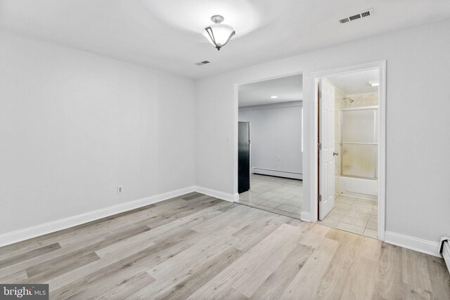 1302 Ashbridge Rd, West Chester, PA 19380 - spare room with baseboard heating, light wood-type flooring, a baseboard heating unit, and baseboards