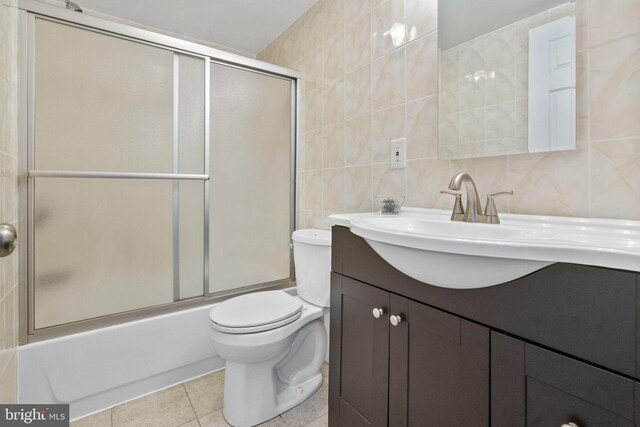 1302 Ashbridge Rd, West Chester, PA 19380 - full bath with tile walls, vanity, toilet, combined bath / shower with glass door, and tile patterned floors