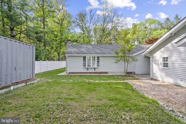 1302 Ashbridge Rd, West Chester, PA 19380 - back of house featuring a chimney, a patio, and a shingled roof
