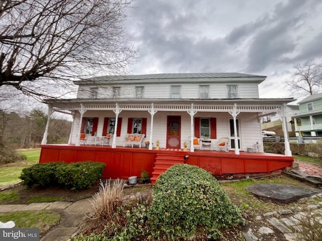 view of front of house featuring metal roof and covered porch