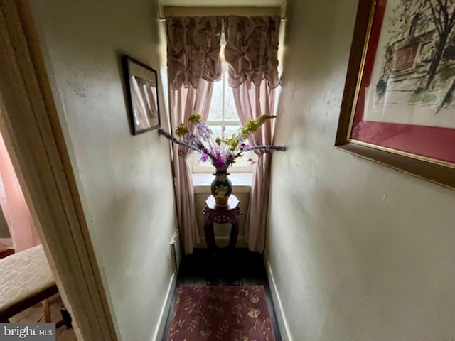 hallway featuring baseboards