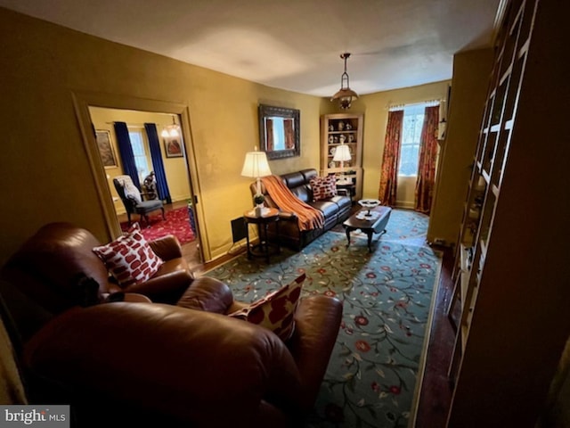 carpeted living area with baseboards