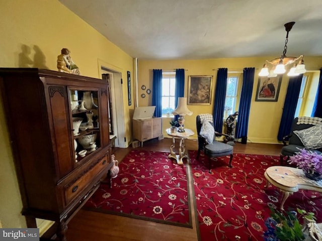 living room with a chandelier and wood finished floors