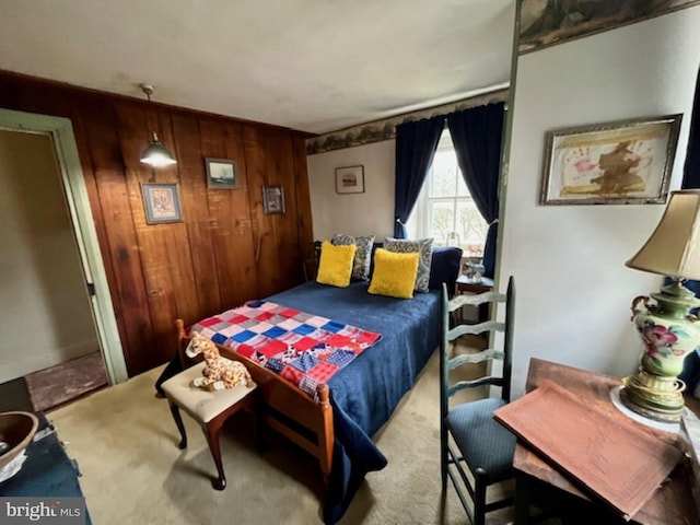 bedroom with wood walls and carpet floors