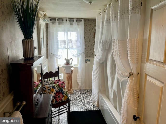 full bathroom with shower / tub combo and wallpapered walls