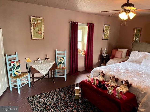 bedroom featuring ceiling fan and wood finished floors
