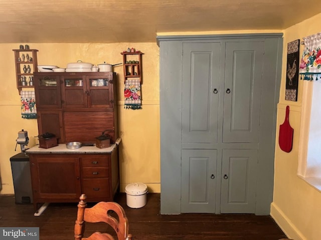 interior space with wood finished floors and baseboards