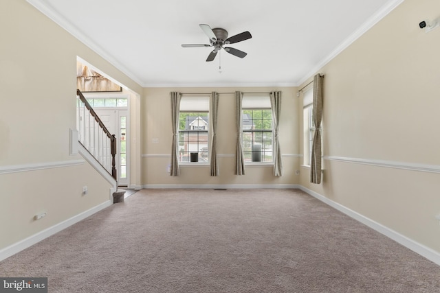 7027 Sand Cherry Way, Clinton, MD 20735 - spare room featuring a ceiling fan, crown molding, stairs, baseboards, and carpet