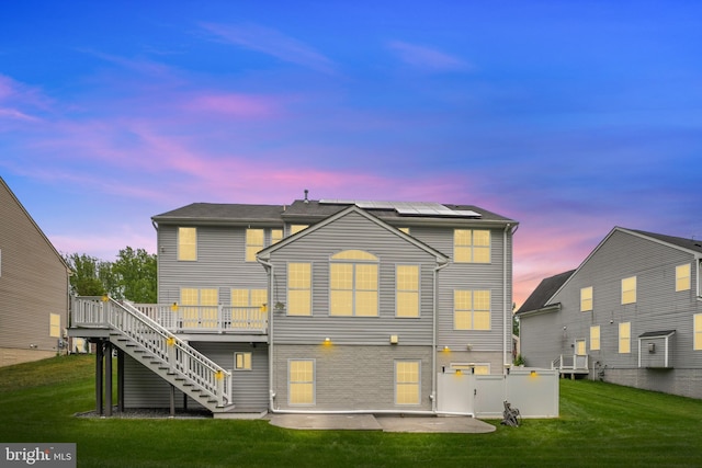 7027 Sand Cherry Way, Clinton, MD 20735 - rear view of house featuring stairway, solar panels, a yard, and a deck