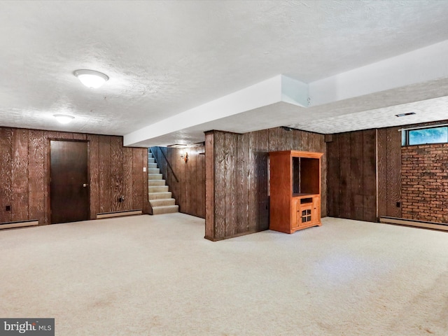 4216 Valley Vista Ct, Manchester, MD 21102 - basement featuring wooden walls, stairway, baseboard heating, a textured ceiling, and carpet