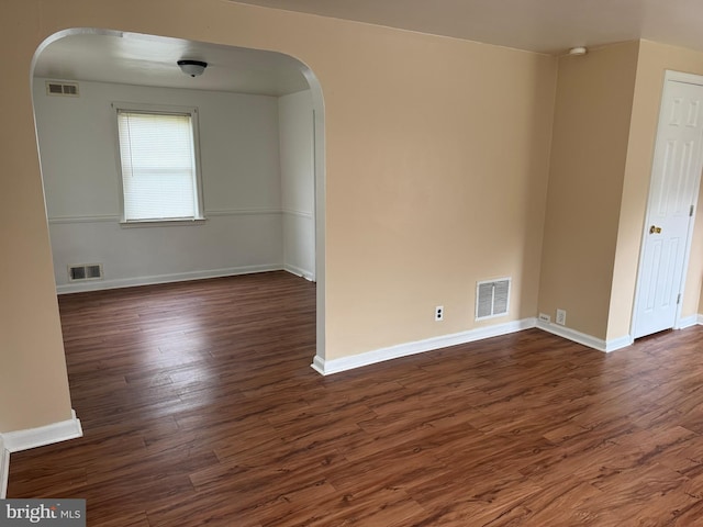 3750 Derry St, Harrisburg, PA 17111 - unfurnished room featuring arched walkways, dark wood-style floors, and visible vents