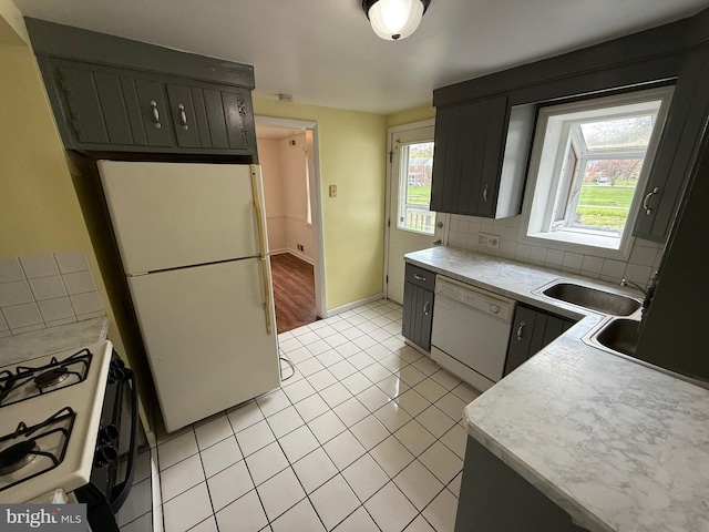 3750 Derry St, Harrisburg, PA 17111 - kitchen featuring white appliances, light tile patterned flooring, light countertops, a sink, and backsplash