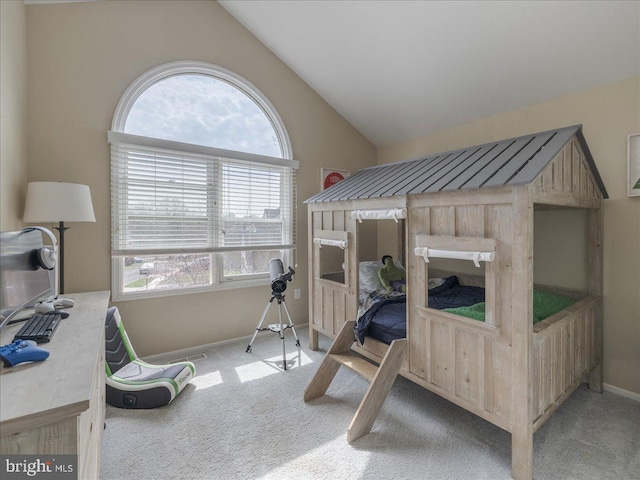 bedroom with carpet floors, multiple windows, and vaulted ceiling
