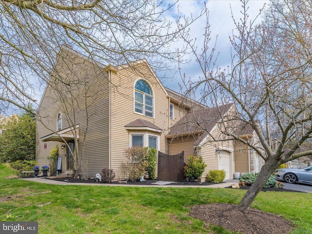 traditional home with a front lawn and a garage