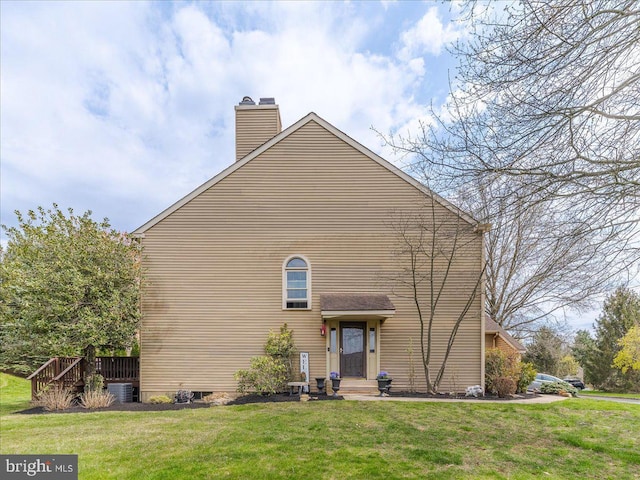 exterior space featuring a chimney and a lawn
